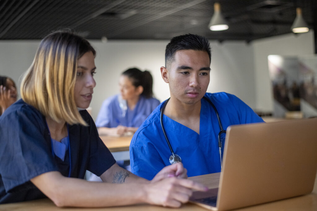 Two medical students work together on a team assignment.